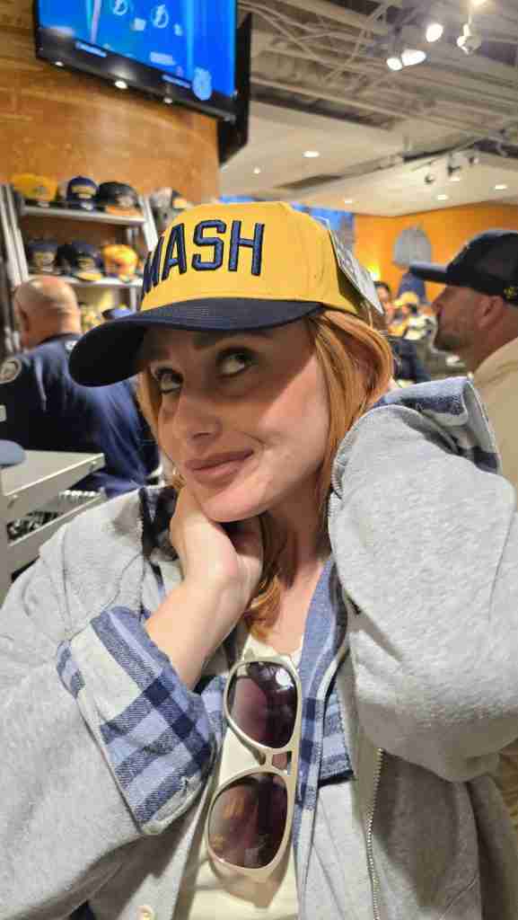 Felicia tries on a "SMASH" hat at the Nashville Predator's Season Opener of the 2024-2025 season.